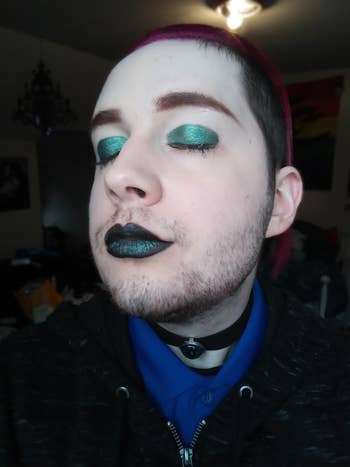 reviewer wearing the dark green shimmery eyeshadow in shade Dynasty