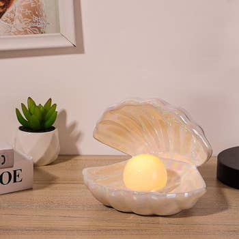 the iridescent shell lamp with pearl light glowing inside