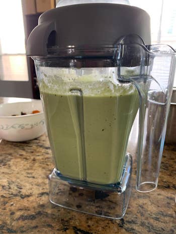 reviewer image of the blender full of a blended green liquid