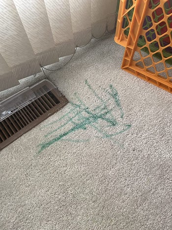 before reviewer image of green marker marks on a beige carpet