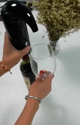 gif of reviewer's wine dispenser pouring wine into a glass