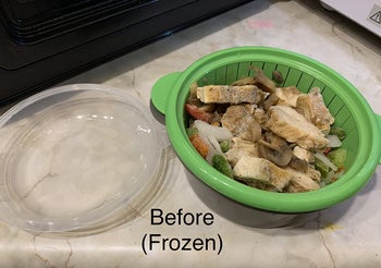 the steamer bowl with frozen chicken strips and veggies in it