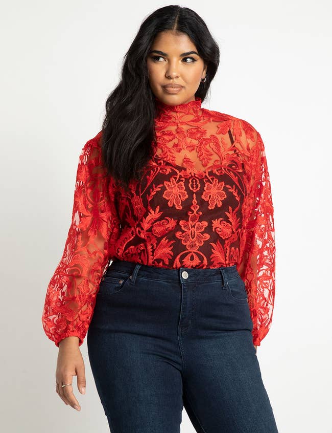 a model wearing the lace top in red