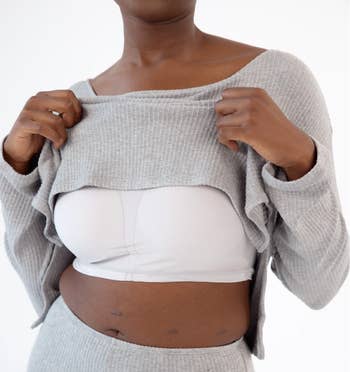 model lifting top to show built in bra 