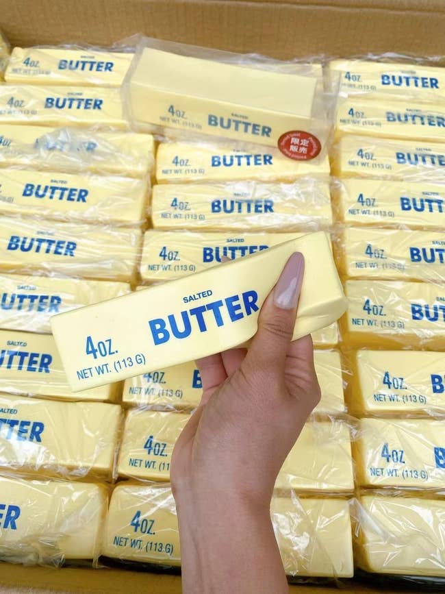 Person holding a butter shaped squeeze toy