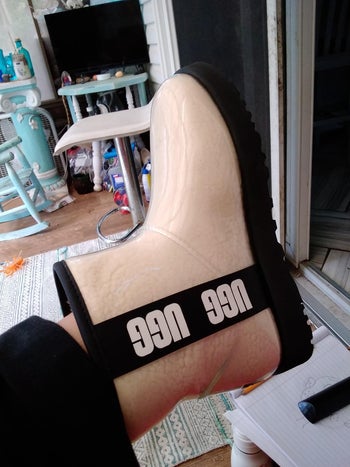 reviewer wearing ugg rain boots