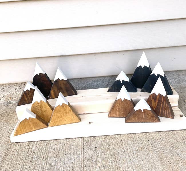 Triangle shaped pieces of wood painted with white peaks 