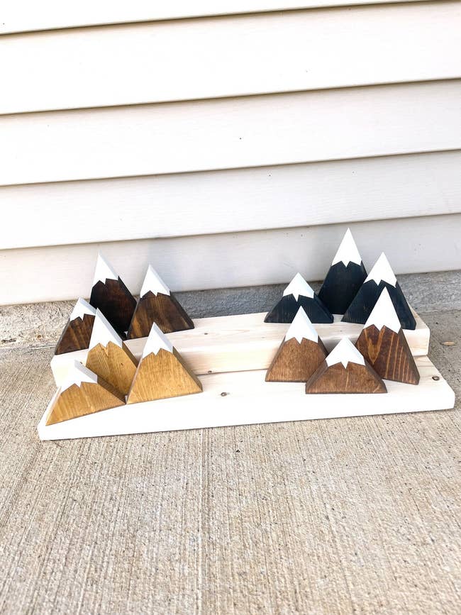 Triangle shaped pieces of wood painted with white peaks 