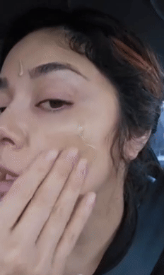 Person applying skincare serum to face, mildly  massaging successful  circular motions