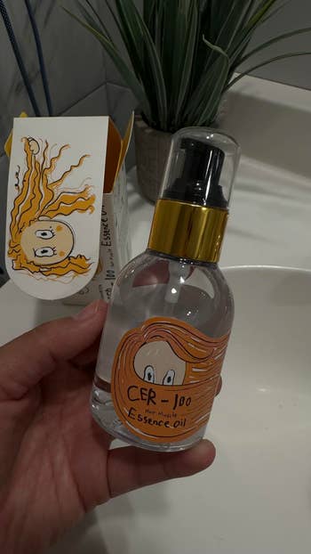 Hand holding a vessel  of hairsbreadth  essence lipid  with cute cartoon quality  packaging, placed adjacent   a plant