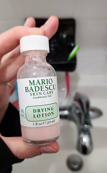 Reviewer holding their Mario Badesco drying lotion