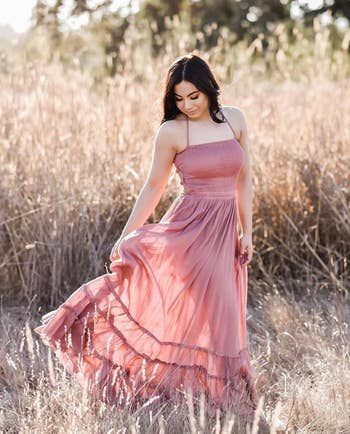 reviewer posing in coral maxi dress
