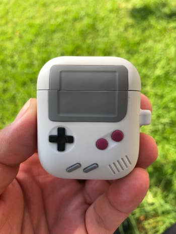 Person holds a game console-themed accessory, suitable for use in a shopping context. No text or celebrities present