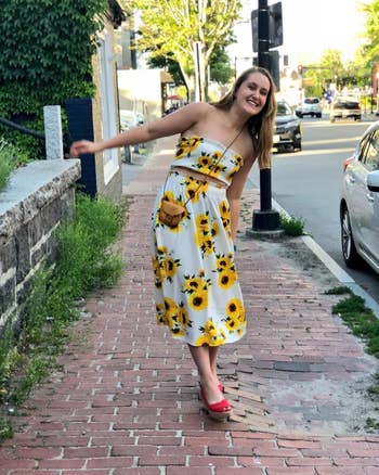reviewer posing in the sunflower print two portion outfit