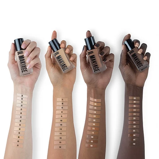 four models holding foundation with swatches of colors on their forearms
