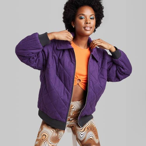 model in zip up purple jacket