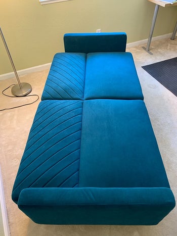 reviewer photo of the couch in a flat, sleeper position 