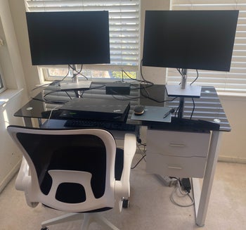 on left: black and white desk chair shown with backrest up