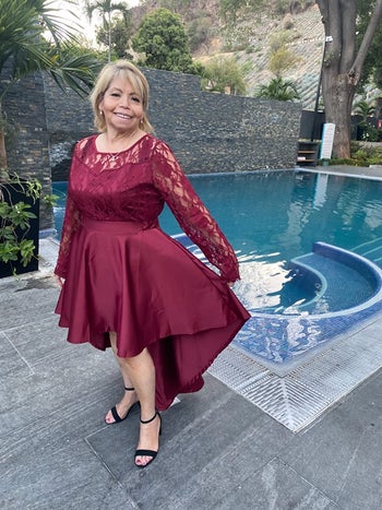 reviewer wearing the burgundy version with black heels