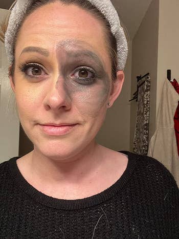 image of reviewer with dark gray makeup over the left side of their face