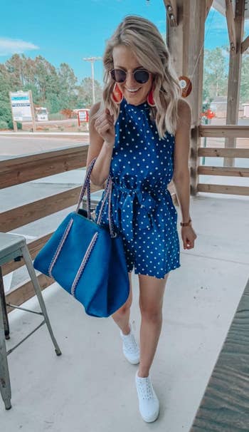 a different reviewer wearing the romper in blue and white polka dot