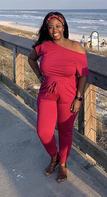 a reviewer wearing the jumpsuit in red 