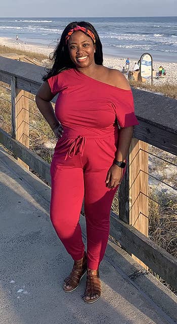 a reviewer wearing the jumpsuit in red 