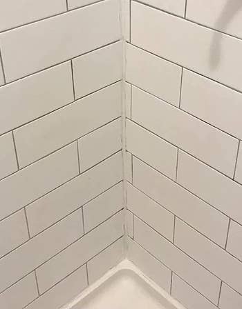 reviewer after photo of the shower grout looking clean and white after being treated with the mold and mildew remover