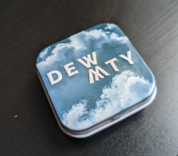 a reviewer photo of a small tin with a cloud print that says 