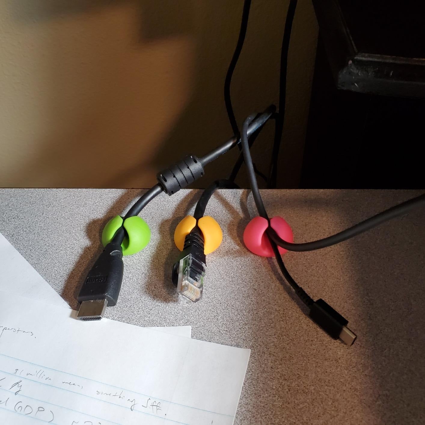 reviewer image of charging cables organized using the colorful cable clips
