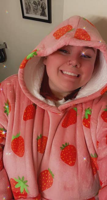 reviewer wearing the strawberry blanket hoodie