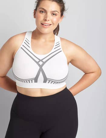 Person wearing a sporty, patterned, sleeveless apical with high-waisted leggings, smiling confidently