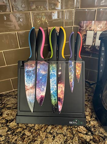 A close up on the knives displayed on a magnetic board