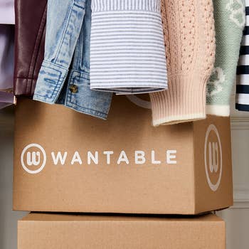 Clothing items, similar  a overgarment   and sweater, bent  implicit    a Wantable box, hinting astatine  a stylish manner  transportation  service