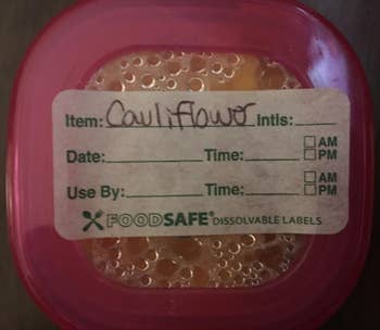 reviewer's cauliflower baby food labeled with one of the more detailed labels that has spaces for dates, times, and use by dates