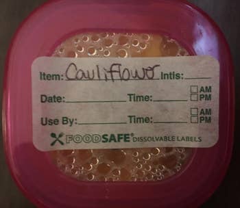 reviewer's cauliflower baby food labeled with one of the more detailed labels that has spaces for dates, times, and use by dates
