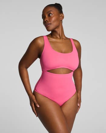 Person successful a stylish, modern swimwear with a cutout design