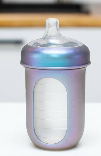 Iridescent baby bottle with silicone nipple