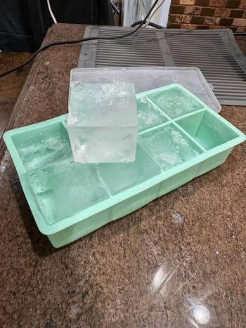 Ice cube tray connected  room  antagonistic  with a ample  wide   crystal  cube placed connected  top