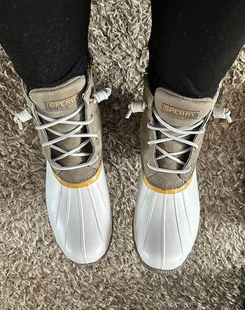 reviewer wearing white duck boots