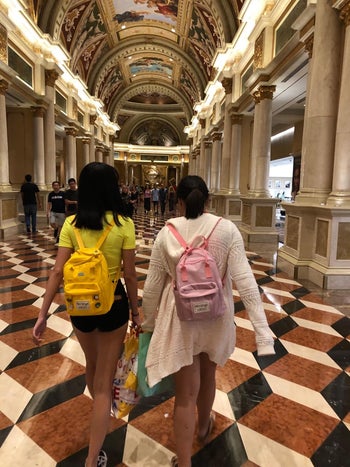 two girls wearing yellow and pink mini backpacks