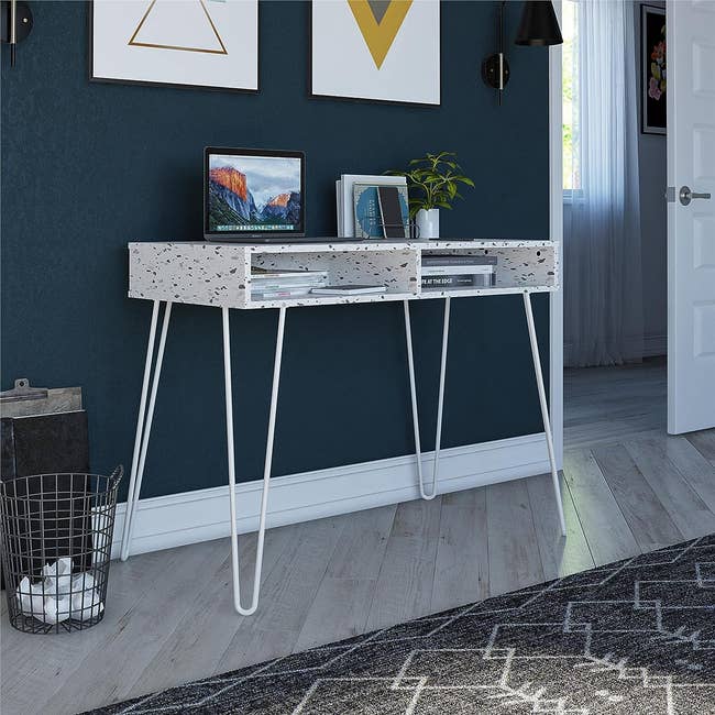 a terrazzo print desk with hairpin legs