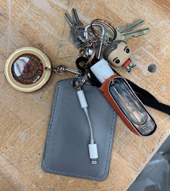 A reviewer's dongle holder attached to a full keychain