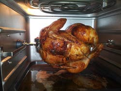 reviewer's rotisserie chicken cooking in air fryer