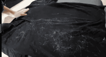 gif of user removing lint from tshirt