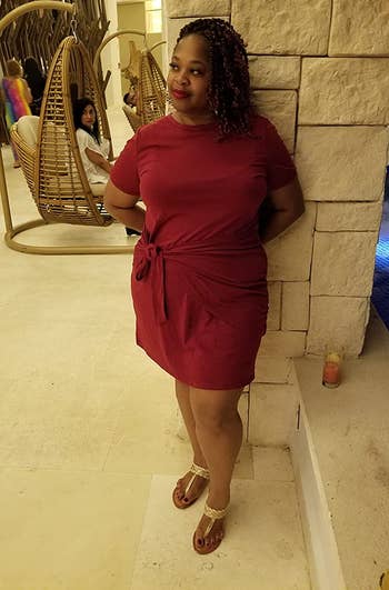 reviewer posing in burgundy dress