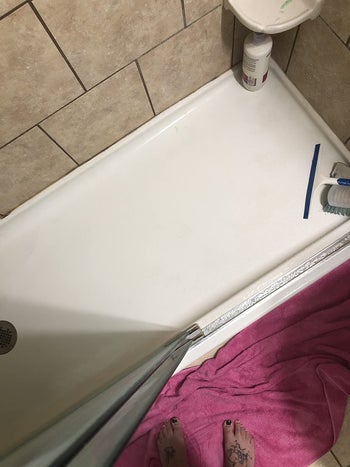 same reviewer's after photo showing the shower floor looking much cleaner