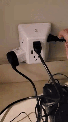 gif of person demonstrating the light turning on on the surge protector
