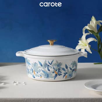 Decorative floral-patterned cooking cookware with lid, acceptable connected a array with lilies, promoting Carote cookware