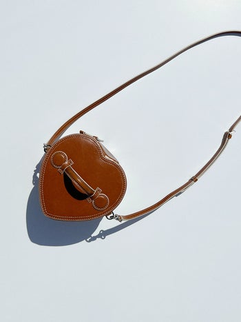 a close up of the brown heart purse